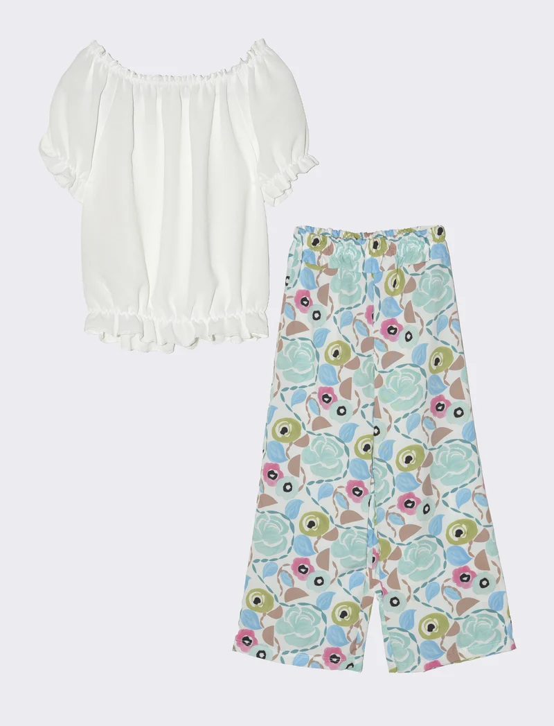 Completo da bambina con blusa e pantaloni fantasia. - Azzurro